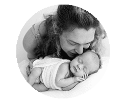 mum kissing sleeping newborn baby, black and white photo