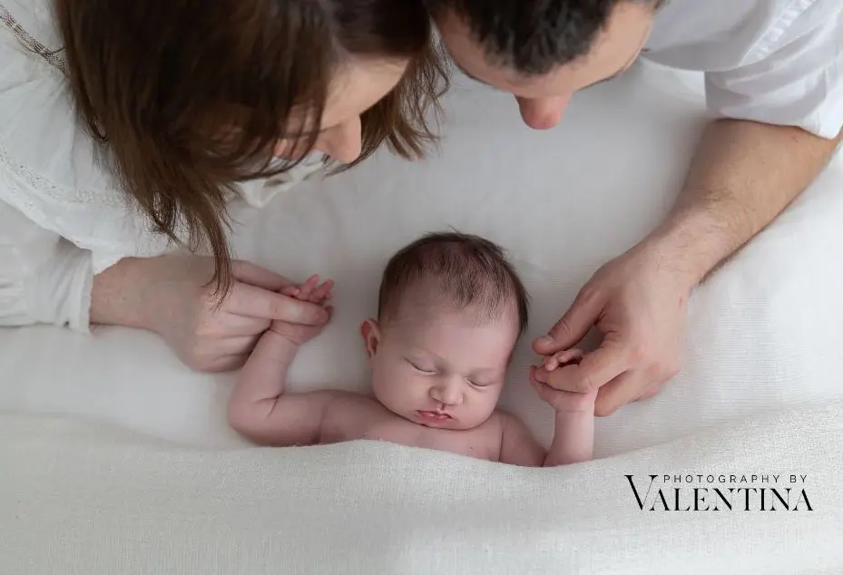 Parents cuddling their newborn baby during a winter newborn session in Richmond.