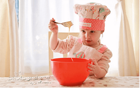 baking cupcakes with children - girl mixing the ingredients