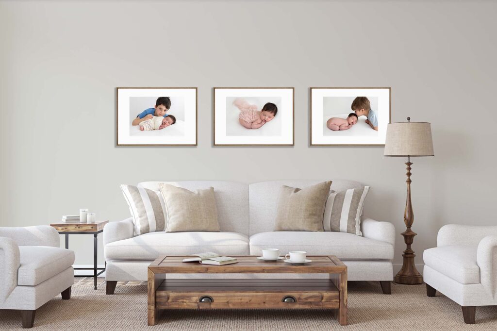 living room displaying 3 framed baby's portraits on the wall