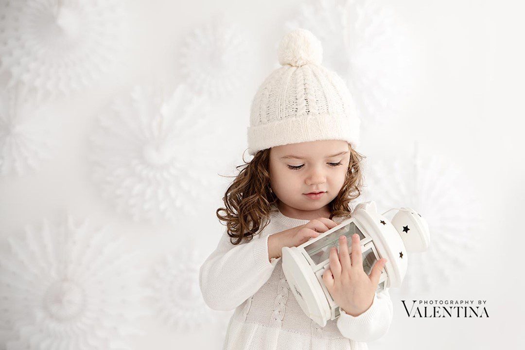 baby girl holding a lantern during Christmas mini session