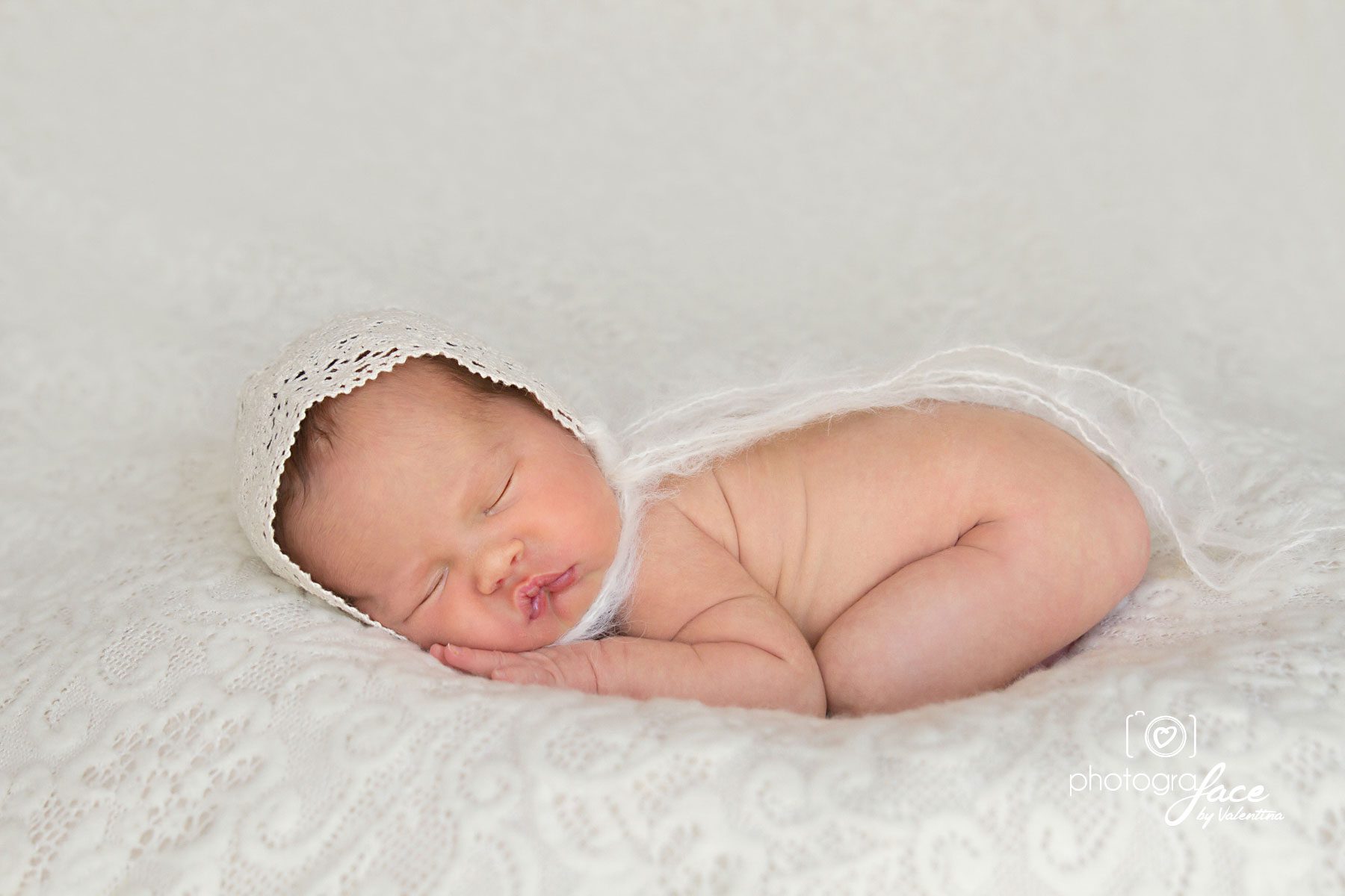 newborn girl sleeping on her tummy in bum-up pose