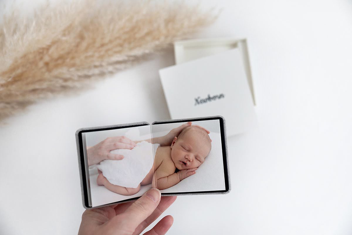 mini accordion album with newborn photos inside