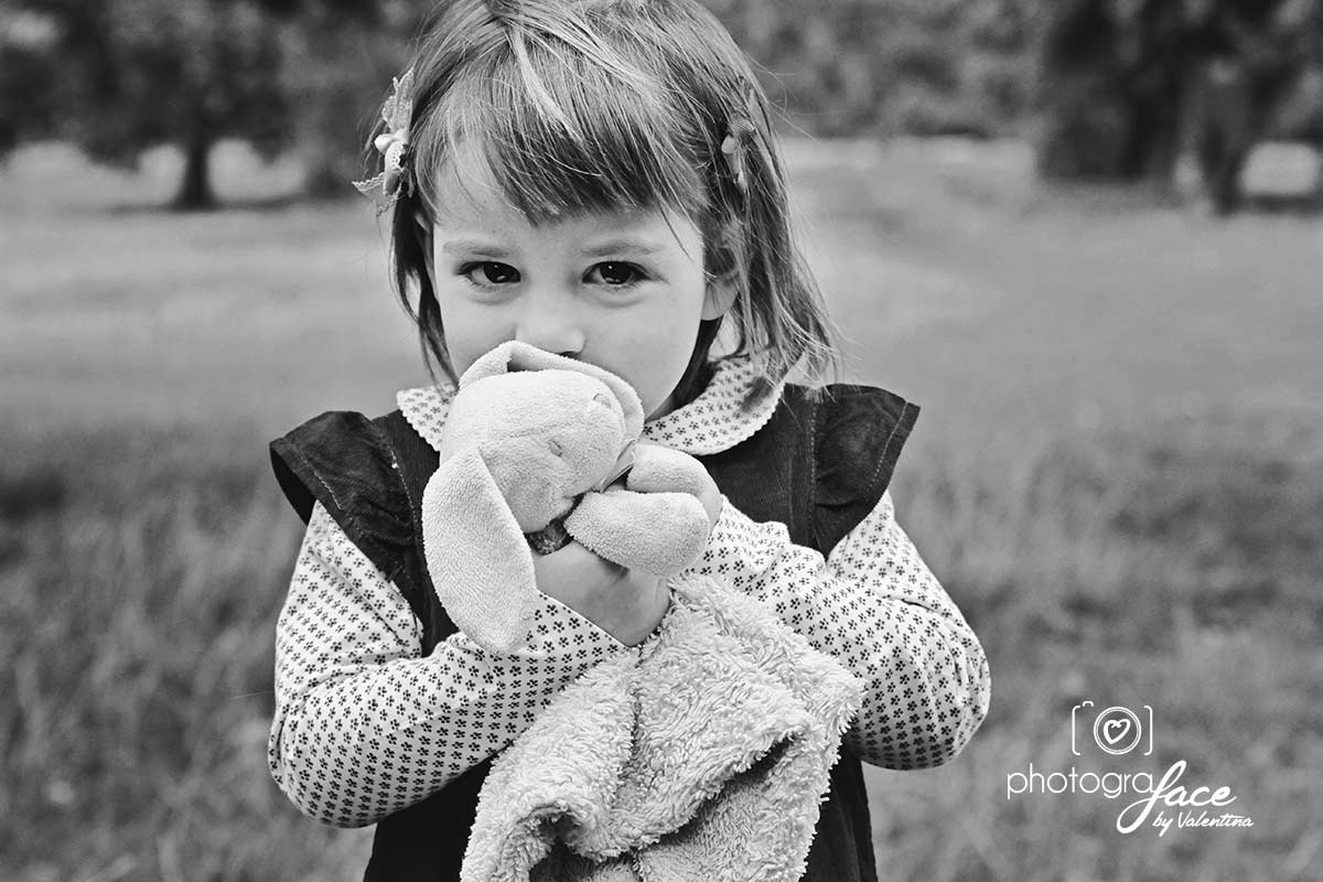 girl hugging soft toy during an outdoor shoot 