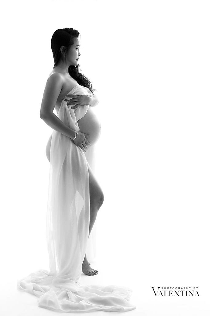 profile of pregnant woman hugged by a beautiful soft light