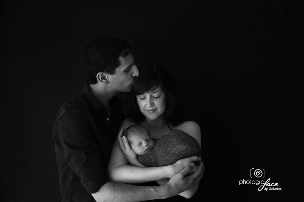 newborn photography: family portrait mum dad and baby, black background