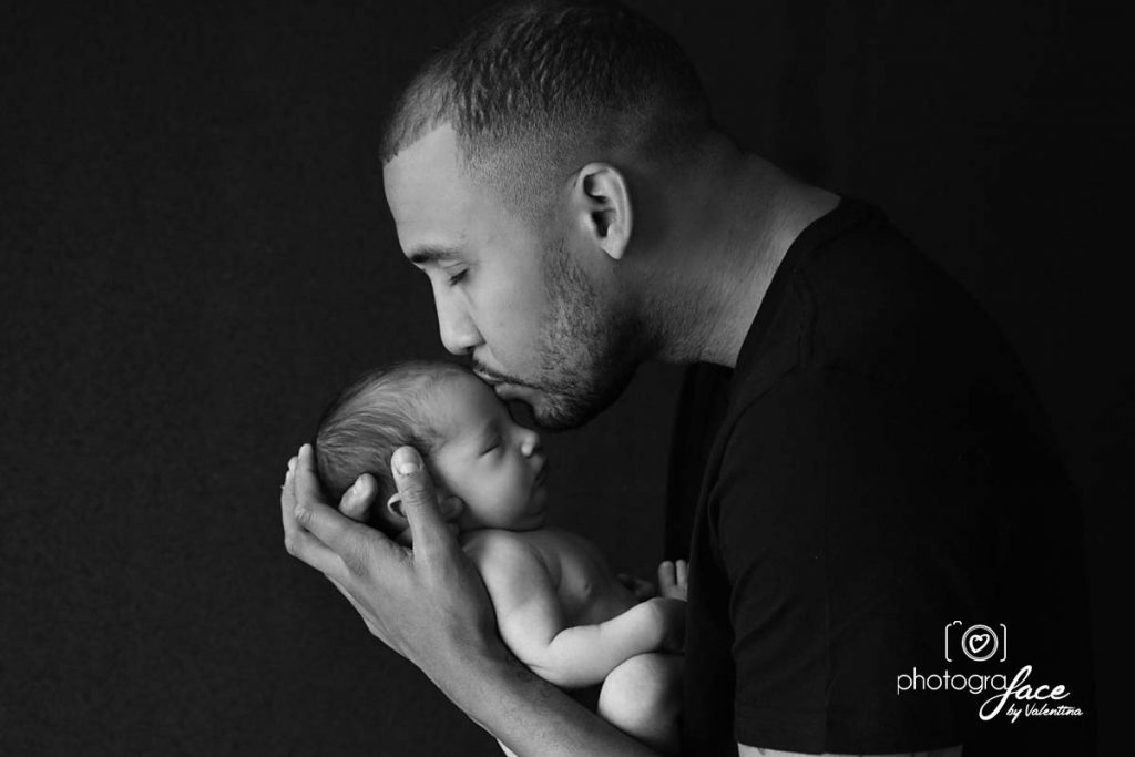 newborn photography: dad kissing baby on his forehead