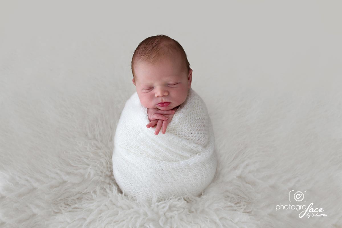 baby wrapped in a soft white wool wrap