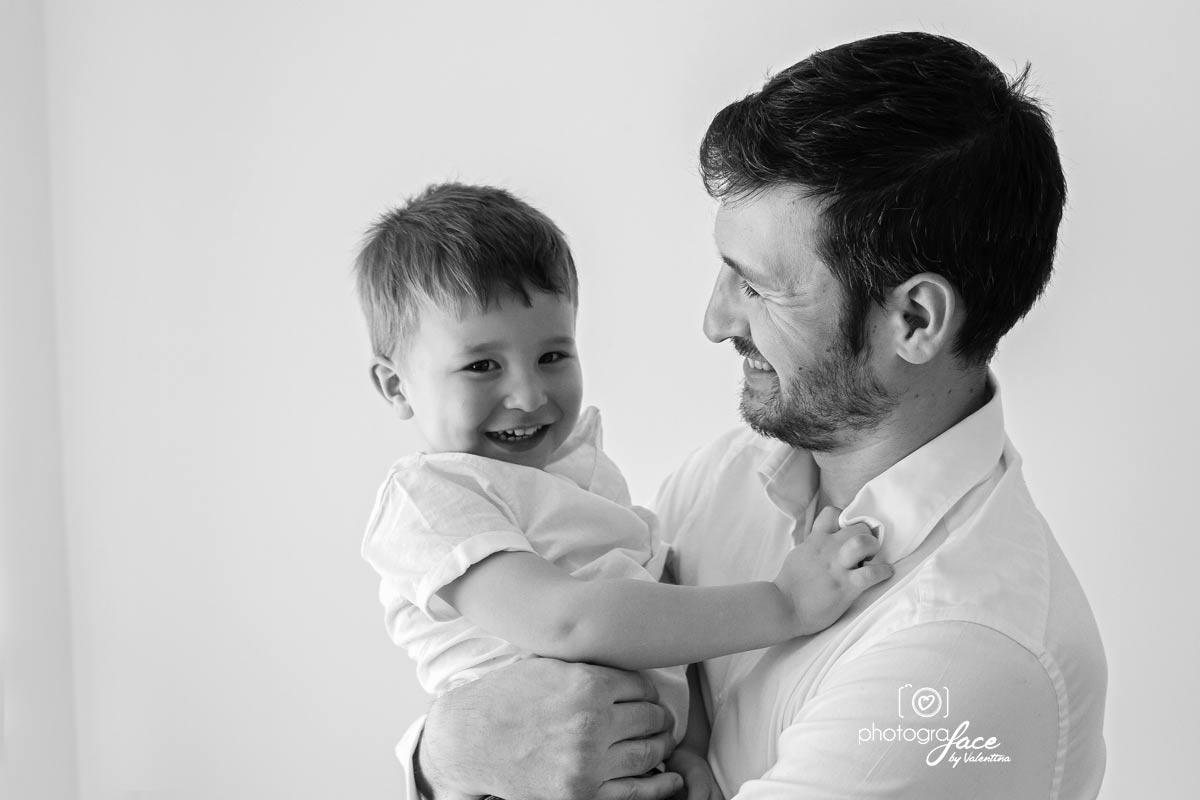 B&W image of son and dad laughing together - baby photography richmond