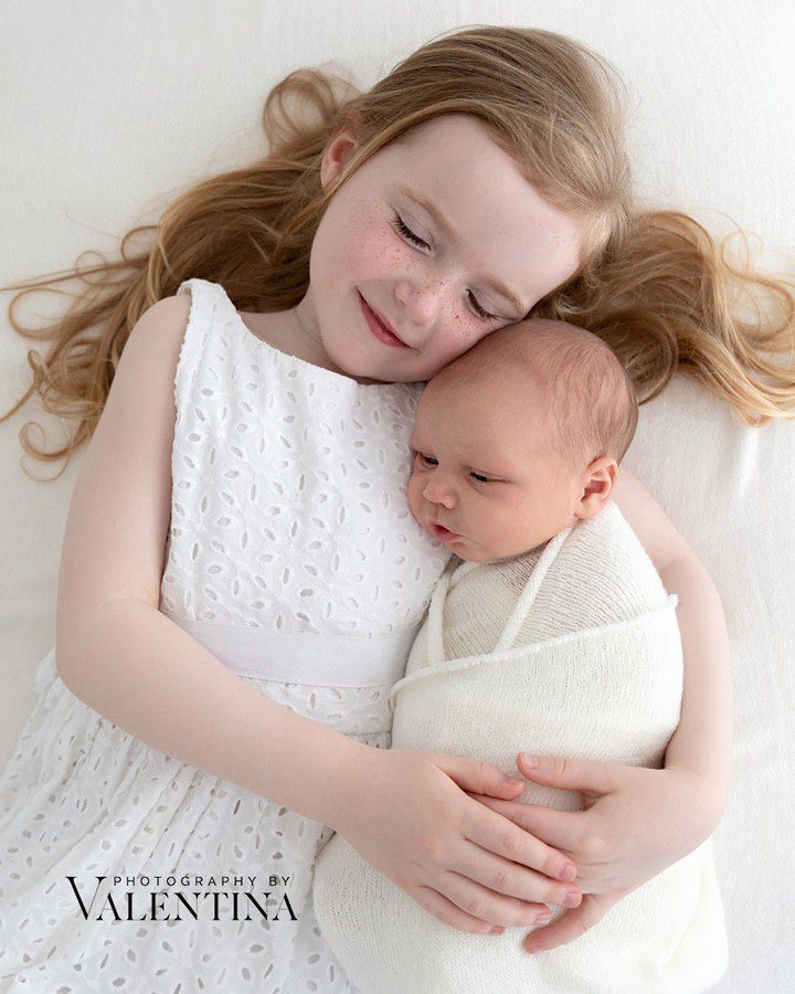 sister holding newborn brother