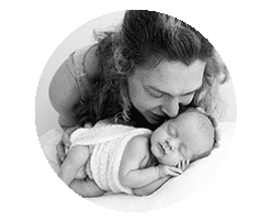 mum kissing sleeping newborn baby, black and white photo