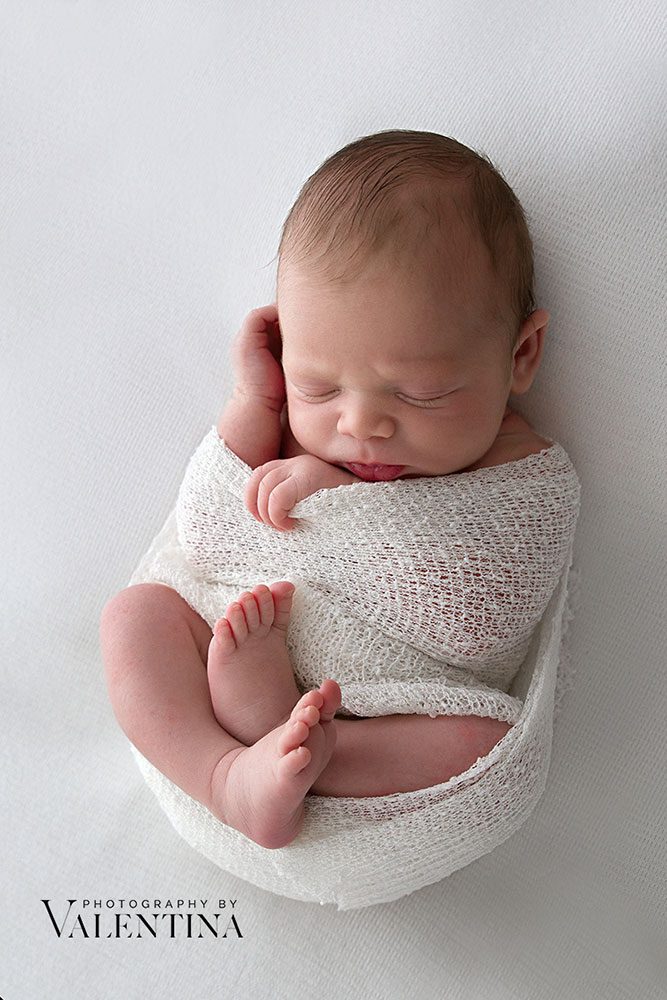 baby wrapped with feet out during a newborn photography session
