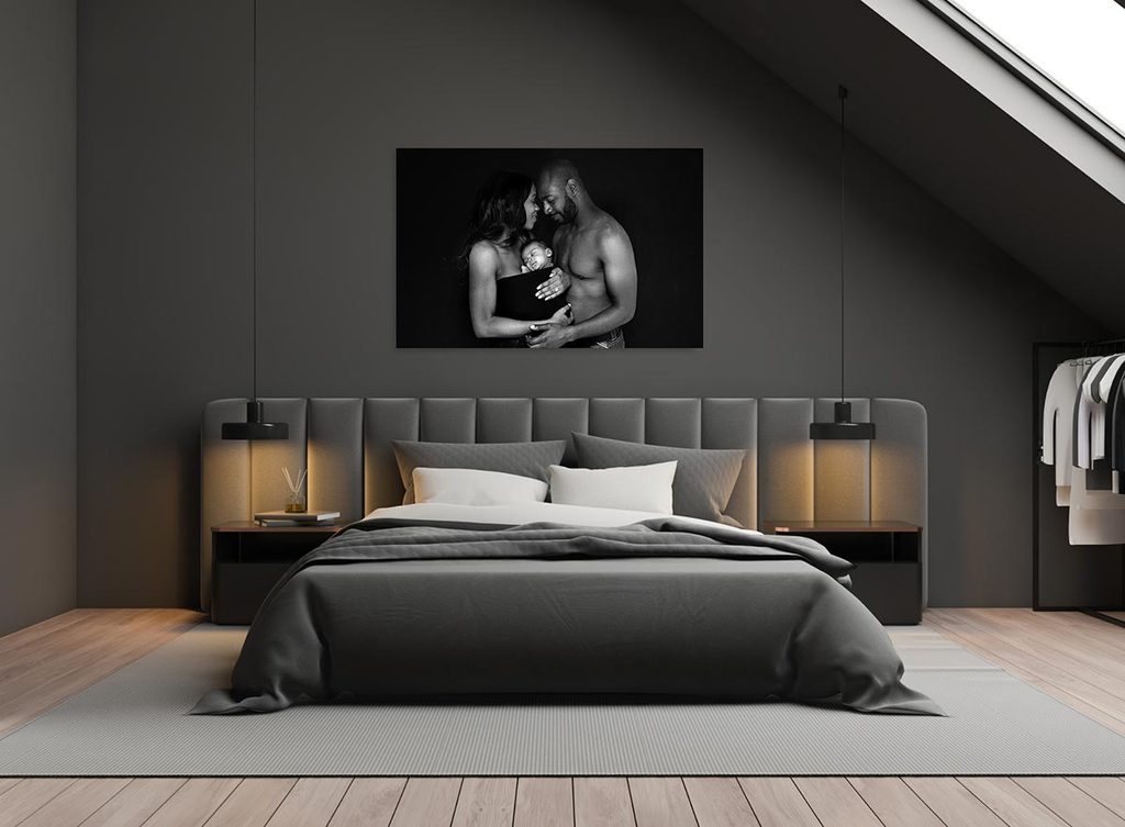 master bedroom with a big  portrait of newborn and family over the bed