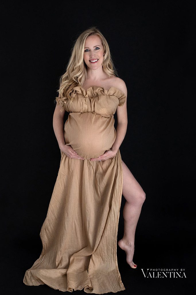 Powerful mum to be looking straight at the camera during her maternity photoshoot.