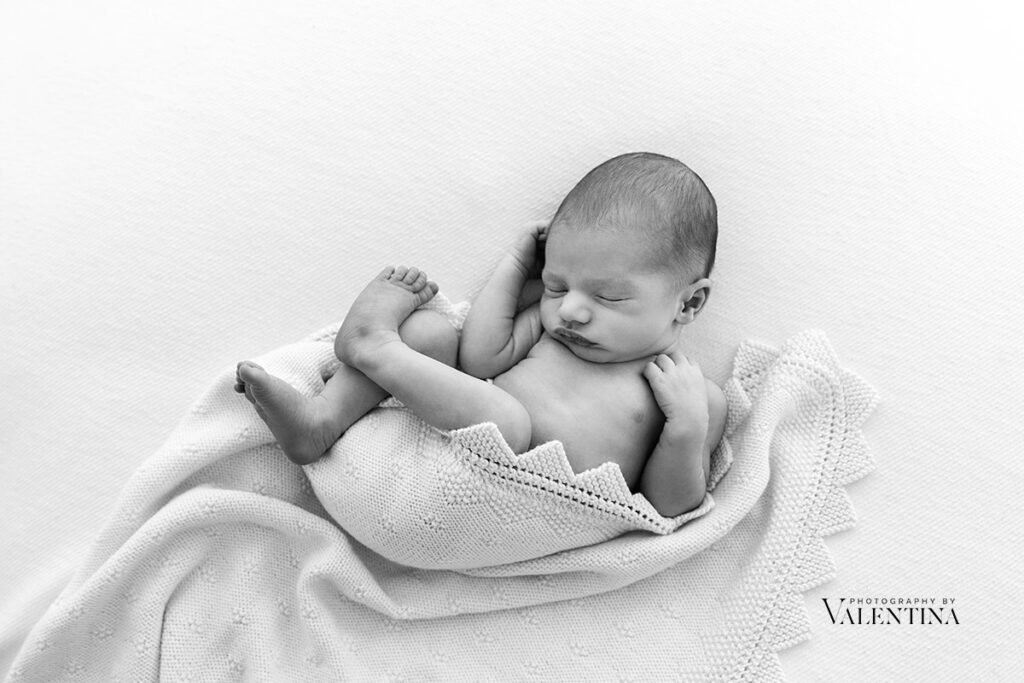 Newborn comfortably posing during a photoshoot in London. 