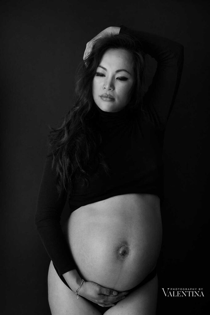 Black and white photo of pregnant woman during her maternity photo shoot. 