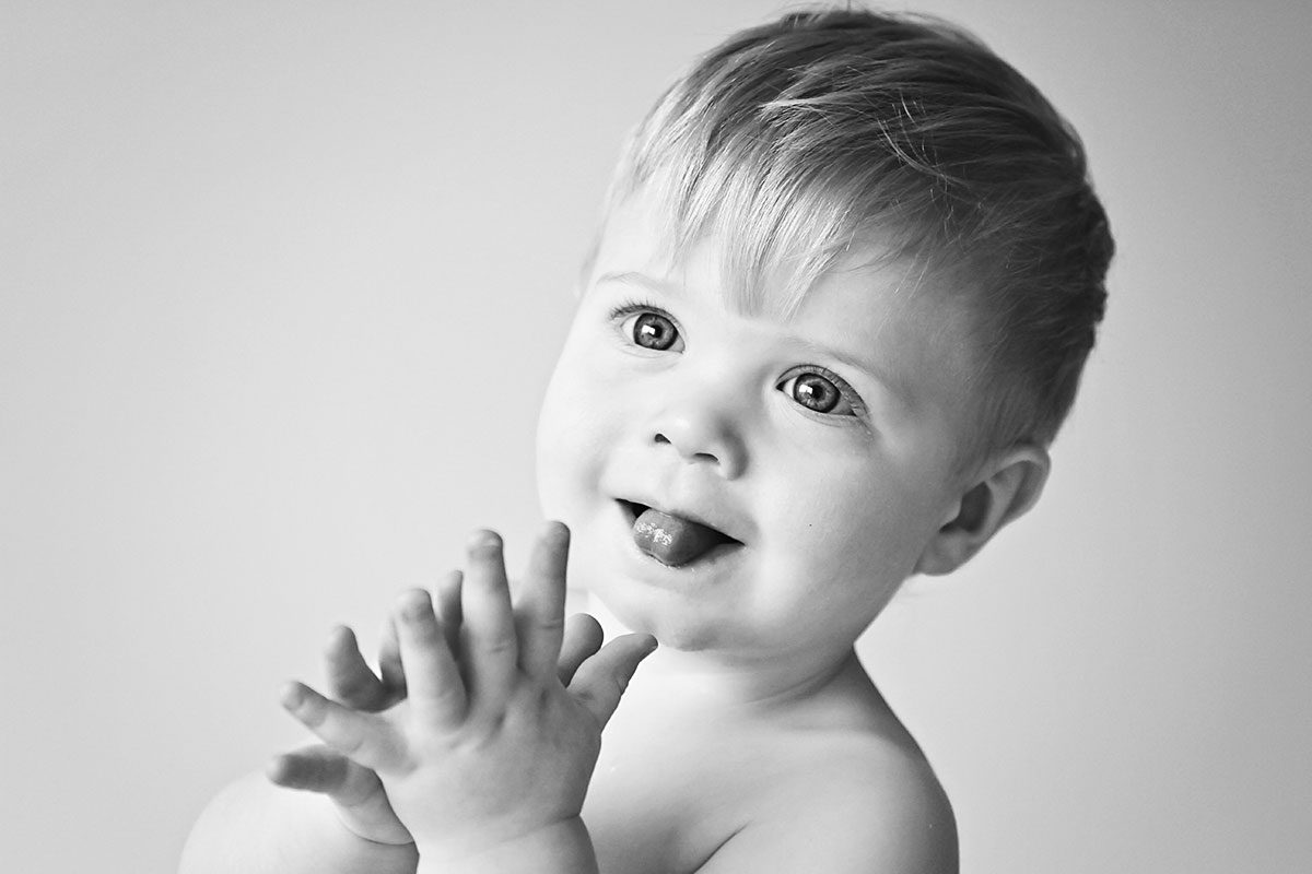one year old baby clapping hands - black and white photography